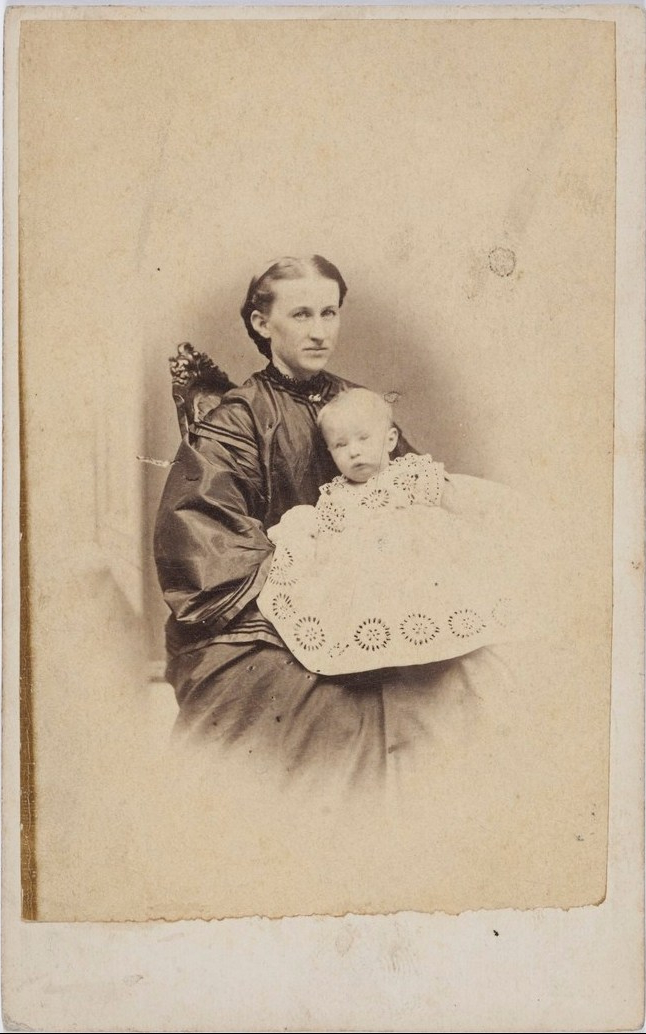 Emily Sarah Coates, wife of Herbert Coates, most likely nursing their son Percy Coates. Emily was the granddaughter of First Fleet convict and wheelwright Hugh Hughes, who is buried at St. John's Cemetery, Parramatta. Photo from Henry William Burgin – studio portraits of Parramatta residents, ca. 1860-1872, Mitchell Library, State Library of New South Wales.